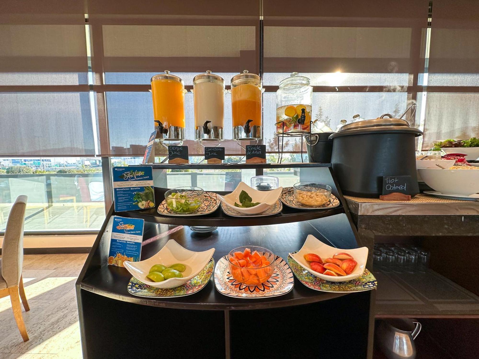 Wyndham Quito Airport Hotel Puembo Exterior photo A selection of fruit and juice at the lounge